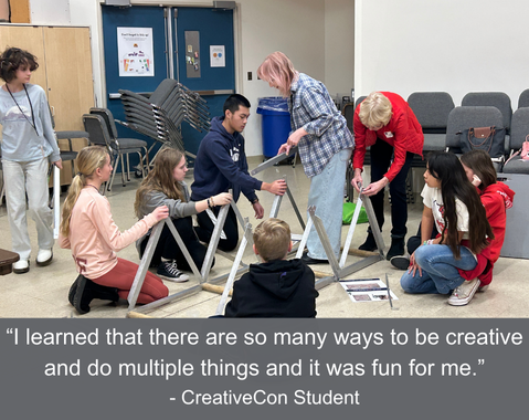 Students collaborate on a creative project using triangular structures in a classroom setting.