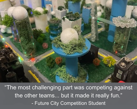 Model city made from craft materials, with quote about a Future City Competition at the bottom.